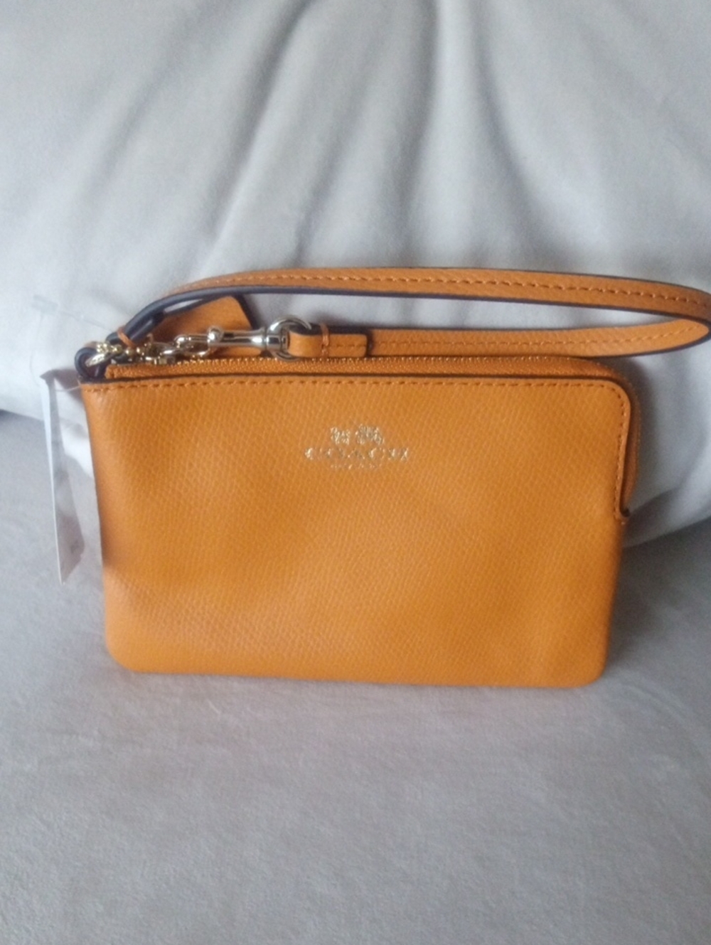 Coach Pebbled Leather Wristlet in Amber